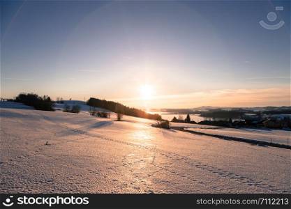 Lake, snowy fields and sundown: scenery at Wallersee, Austria