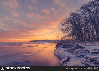 Lake sunrise with ice in the winter