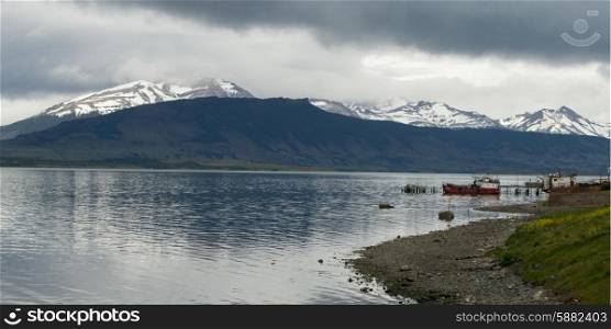 Lake with mountain range in the background, Golfo Almirante Montt, Puerto Natales, Patagonia, Chile