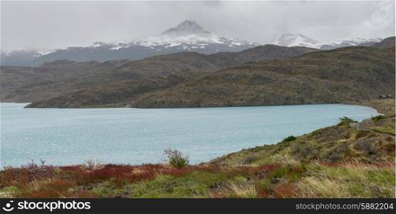 Lake with mountain range in the background, Lake Pehoe, Torres Del Paine National Park, Patagonia, Chile