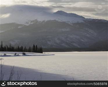 Lake with mountain range in the background, Muncho Lake, Muncho Lake Provincial Park, Northern Rockies Regional Municipality, British Columbia, Canada