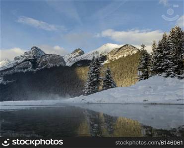 Lake with mountains in winter, Lake Louise, Banff National Park, Alberta, Canada