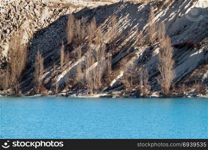 Lake with turquoise waters. Lake emerald-turquoise color formed in an old quarry