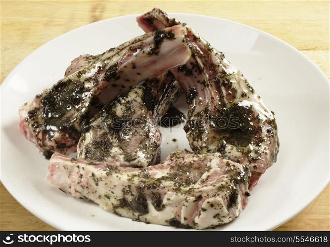 Lamb chops coated with a mint marinade read to go on a barbecue grill