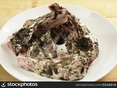 Lamb chops coated with a mint marinade read to go on a barbecue grill