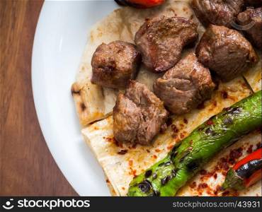 Lamb kebabs with flatbread, tomato and pepper