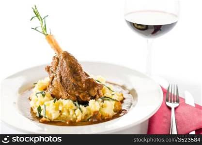 Lamb knee in sauce with mashed potatoes on white background