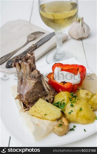 lamb loin chops with baked potatoes on wooden table