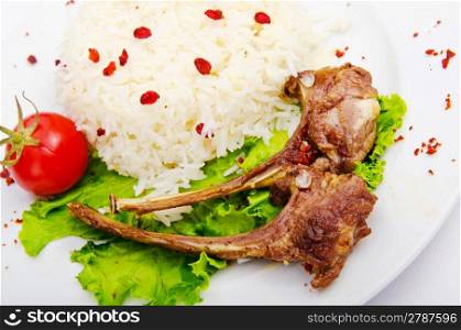 Lamb ribs with rice served in the plate