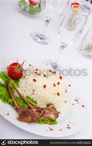 Lamb ribs with rice served in the plate