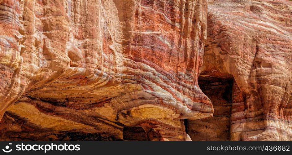 Laminated sandstone in Petra, Jordan, with strong red, yellow, orange and brown colours, middle east