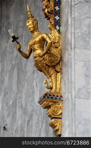 Lamp and golden Buddha on the corner of marble wall of temple in wat Hualampong, Bangkok, Thailand