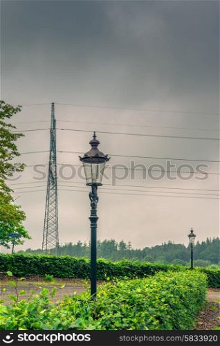 Lamp and pylons in cloudy weather