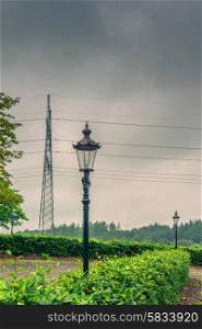Lamp and pylons in cloudy weather