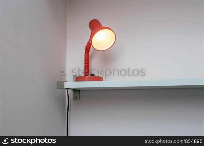 Lamp night light on shelf with white wall background, space for text close up. Lamp night light on shelf with white wall background, space for text