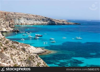 Lampedusa island, Mediterranean Sea, Italy: boats anchored in port behind island