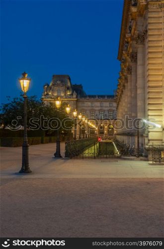 Lampost array outside the Louvre Museum in Paris, France early in the evening