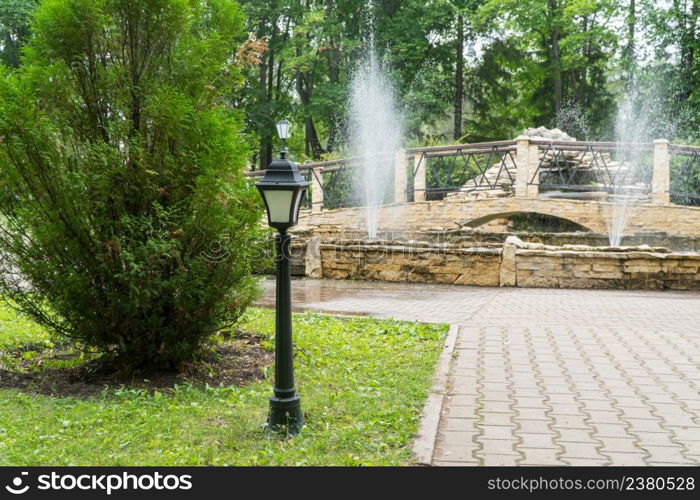 lamppost on the background of the fountain in the Park. lamppost in the Park