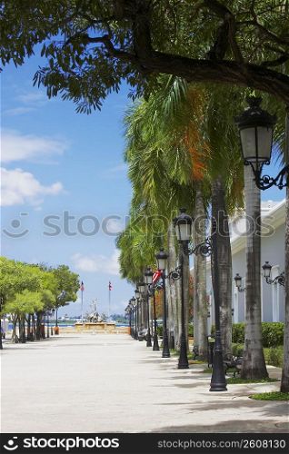 Lampposts and trees in front of a building, La Princesa, Old San Juan, San Juan, Puerto Rico