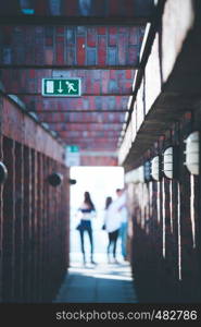 Lamps on a masoned building, blurry background with people