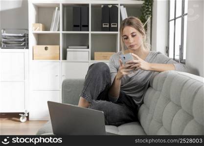 lancer sitting couch with phone