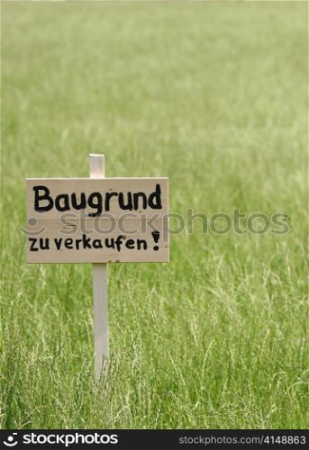 land for sale sign on to a meadow.