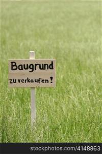 land for sale sign on to a meadow.