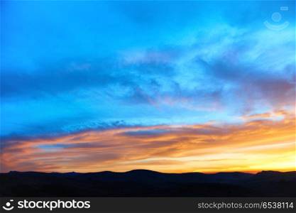 Land with and dramatic colorful sky at sunset. Land and dramatic sky