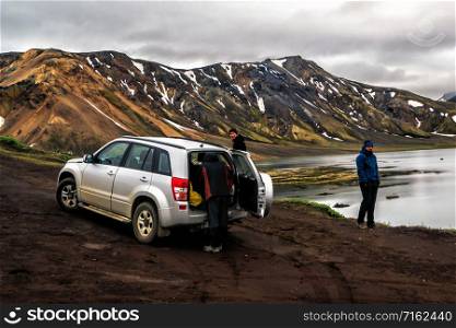 Landmannalaugar, Iceland - July 2, 2018: 4WD vehicle car travel off road in landscape of Landmannalaugar in highland of Iceland, Nordic, Europe. The place is famous for summer outdoor trekking way.