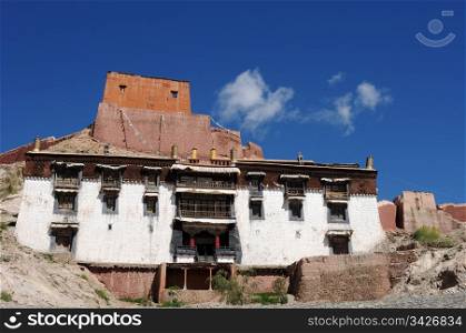 Landmark of typical historic Tibetan buildings against blue sky