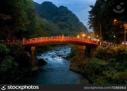 Landmark Red bridge over river creek in Nikko Tochigi Japan at twilight dusk sunset.