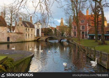 Landscape at Lake Minnewater with church and bridge in Bruges, Belgium