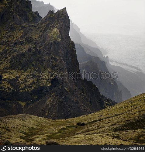 Landscape, craggy mountain valley overlooking glacier field