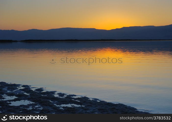 Landscape Dead Sea shortly before dawn, salt, water and the Jordanian mountains in the background.