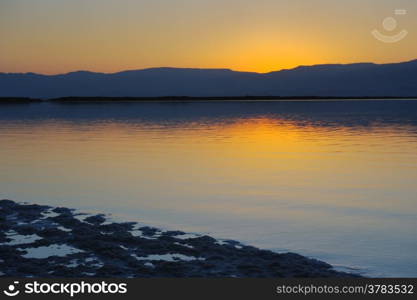 Landscape Dead Sea shortly before dawn, salt, water and the Jordanian mountains in the background.