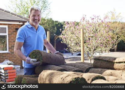 Landscape Gardener Laying Turf For New Lawn