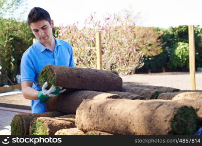 Landscape Gardener Laying Turf On New Lawn