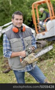 Landscape gardener with a chainsaw