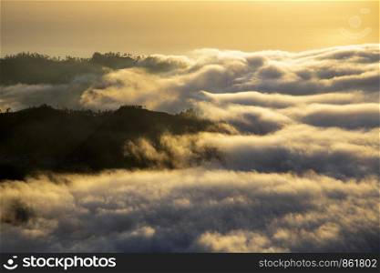 Landscape hiding in sea of ??clouds and fog at daybreak