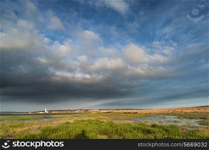 Landscape image large Summer sky with lighthouse in distance