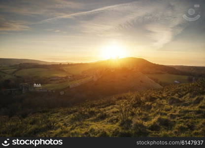 Landscape image of enchanting fairytale castle ruins during beautiful sunset