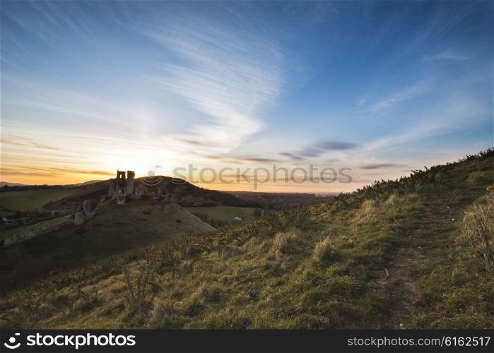 Landscape image of enchanting fairytale castle ruins during beautiful sunset
