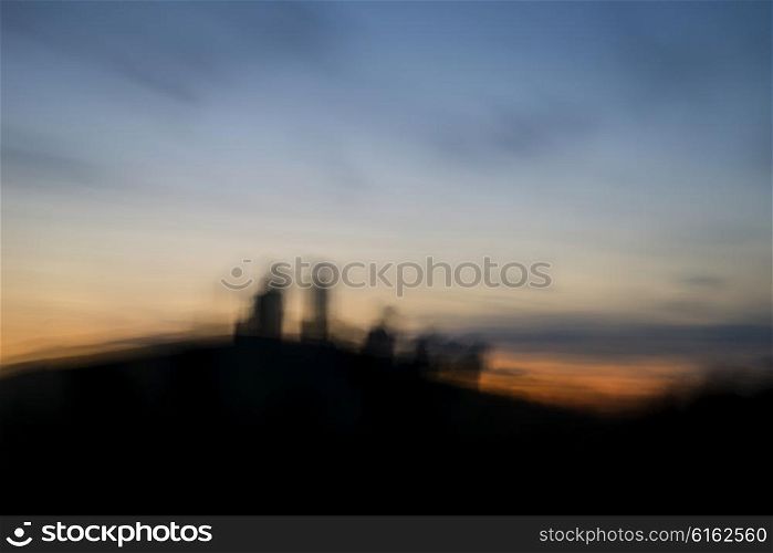 Landscape image of enchanting fairytale castle ruins during beautiful sunset with blur filter applied