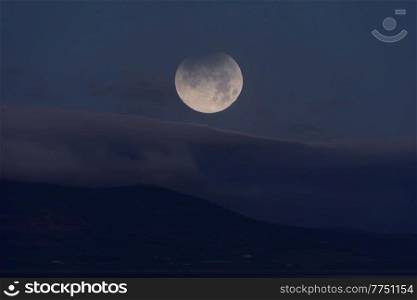 Landscape image of partial lunar eclipse during November 2021 which conincided with blood red moon phoase