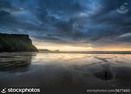 Landscape image of shipwreck on beach at sunset in Summer