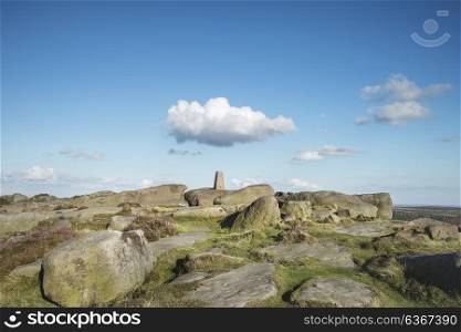 Landscape image of trig point on top of Stanage Edge in Peak District