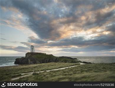 Landscape image of Twr Mawr Lighthouse on Ynys Llanddwyn Island in Angelsey at sunset