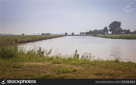 landscape in holland at the river Eem with trees at the horzion and grass in foreground. landscape with water trees and horizon. landscape with water trees and horizon