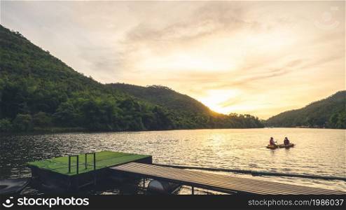Landscape in the evening with people rowing on river at Kanchanaburi ,Thailand