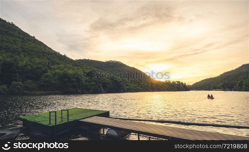 Landscape in the evening with people rowing on river at Kanchanaburi ,Thailand